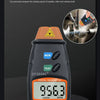 A black digital tachometer measuring 956.3 RPM, used for non-contact measurement of rotating shafts.