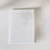 A clear plastic die and stamp set for card making is displayed on a white surface.