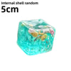 A translucent teal cube shaped like an ocean shell with various sea creatures inside.