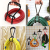 Various heavy-duty hook and loop storage straps in red, green, and yellow coiled on a wooden surface.