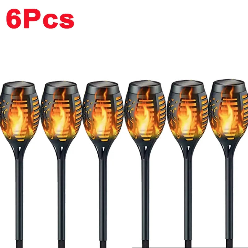 Six solar flame torch lights displayed in a row, showing bright orange and yellow flames.