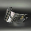 Clear plastic replacement motorcycle helmet visor shown from a slight angle.