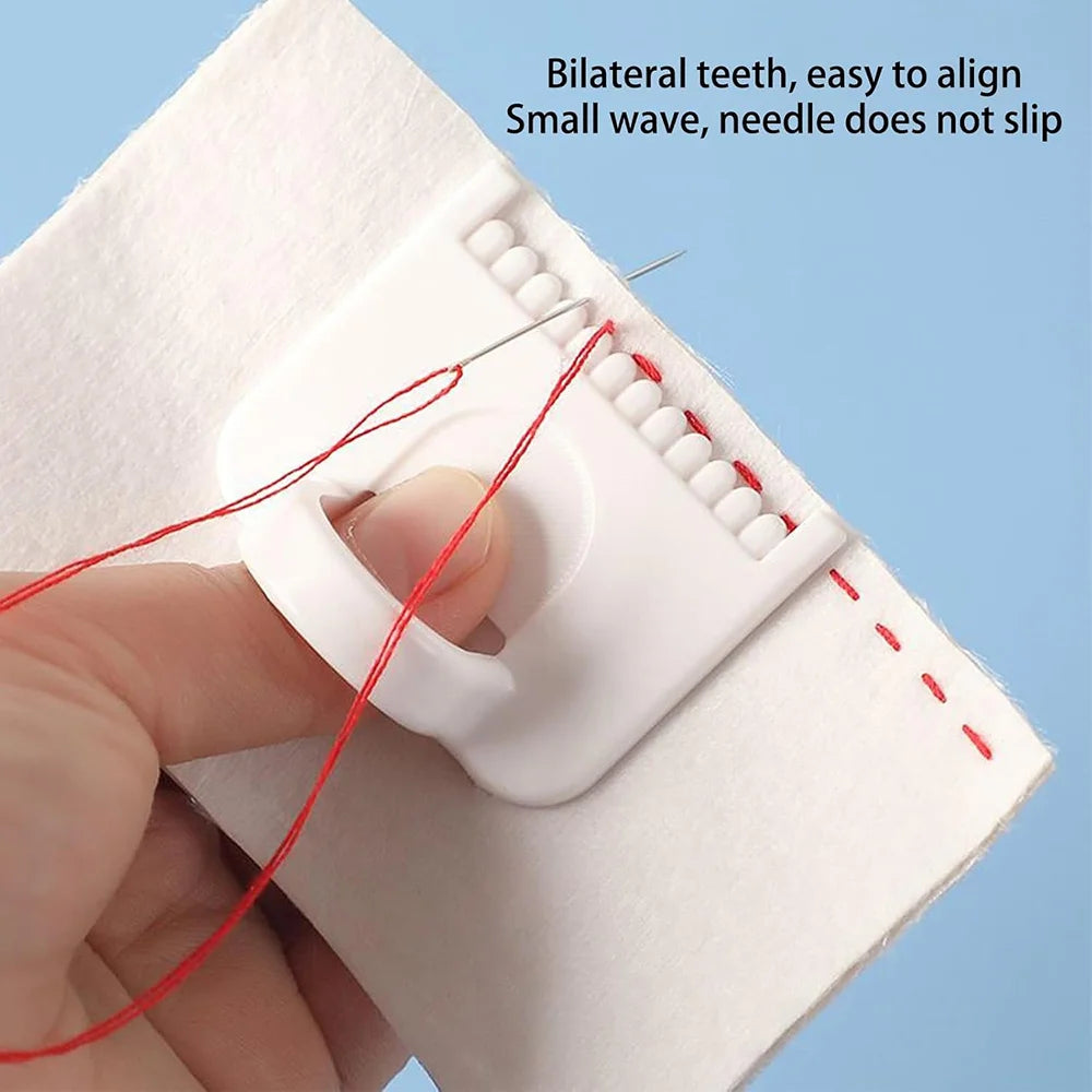 A hand is using a white sewing guide template with red thread to align and stitch two teeth.