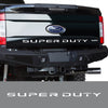 Close-up view of a black Ford Super Duty truck tailgate with the Super Duty emblem and lettering.