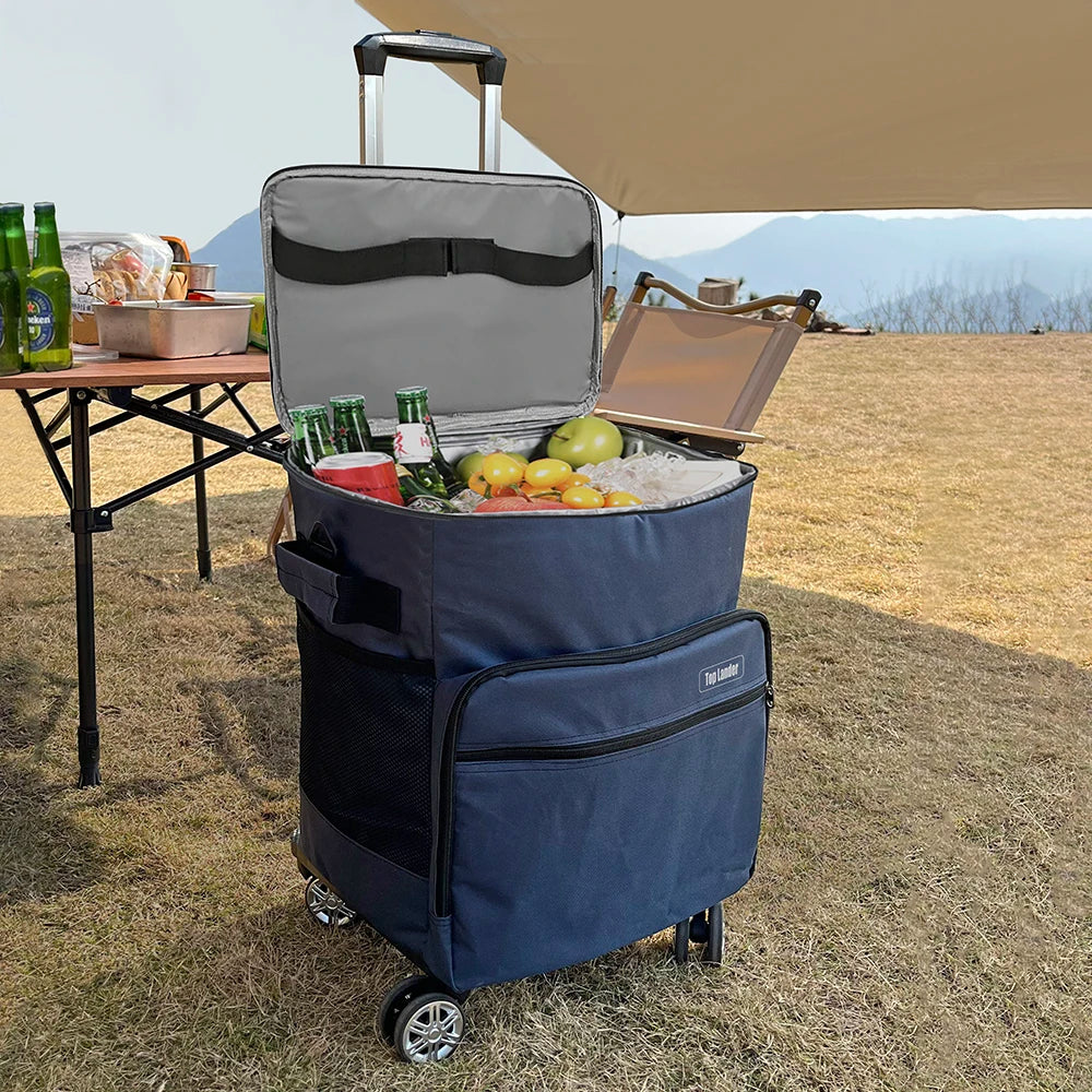 Una bolsa isotérmica azul abierta, mostrando frutas y bebidas en una mesa de picnic bajo un gran toldo.