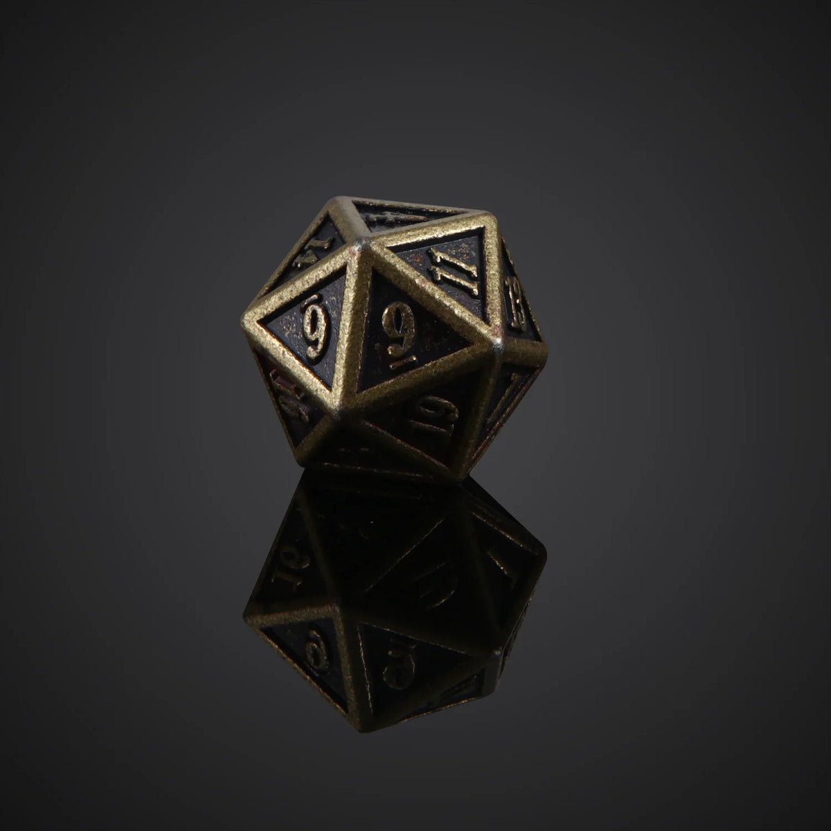 A bronze metal polyhedral dice set, likely a d10, resting on a reflective surface.