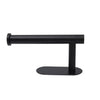 A black stainless steel self-adhesive toilet paper holder with a flat base.