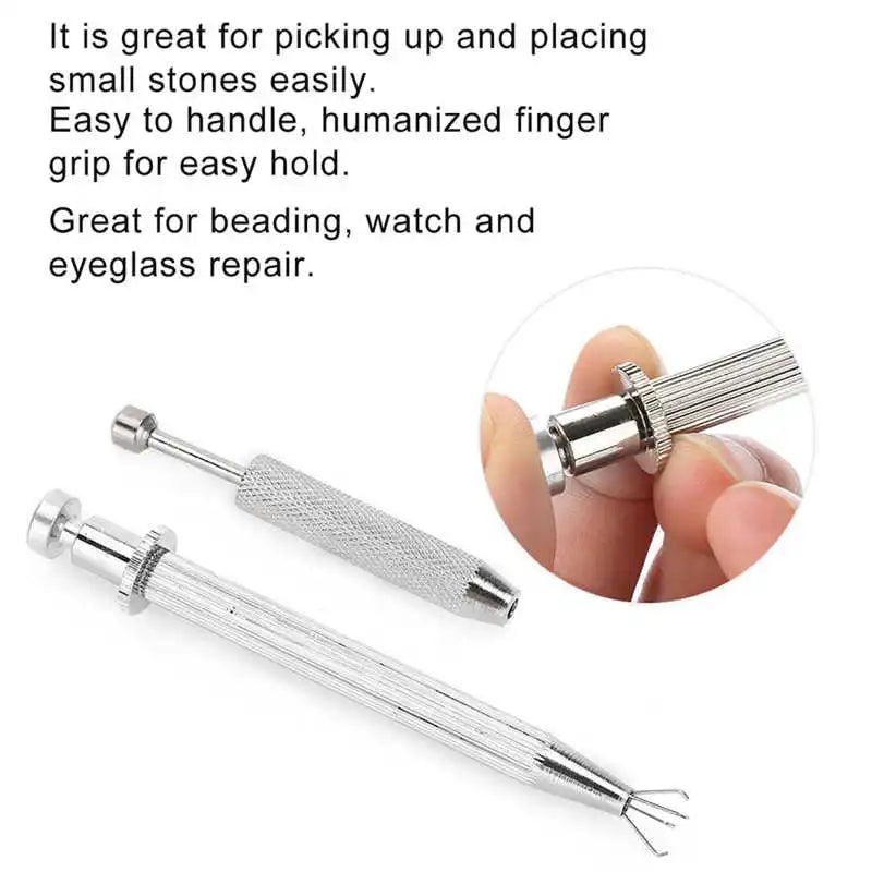 A silver precision pick-up tool with a sharpened tip is shown being held by a hand.