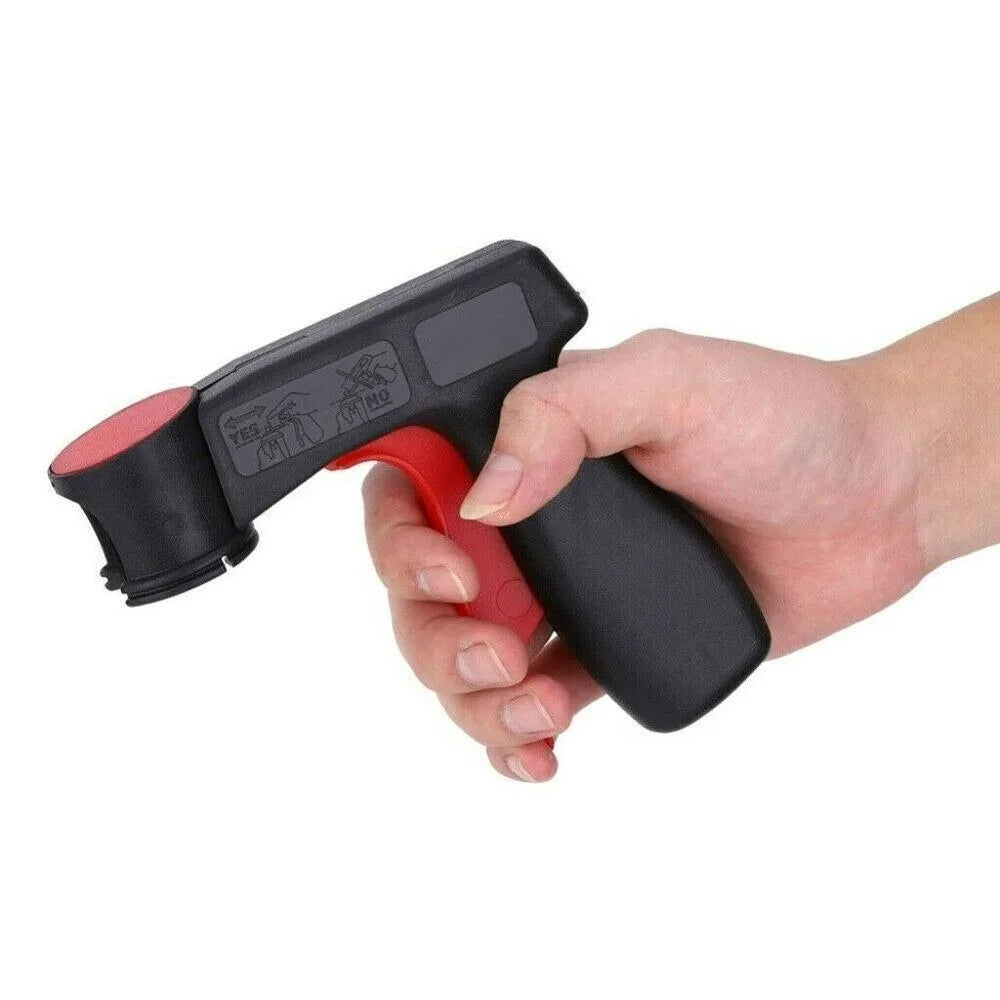 A hand holds a black and red ergonomic spray paint gun handle for aerosol cans.