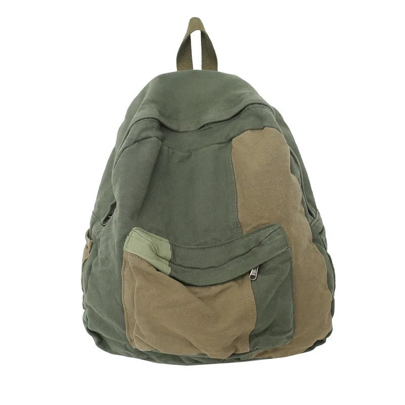 A olive green canvas patchwork backpack with brown accents.