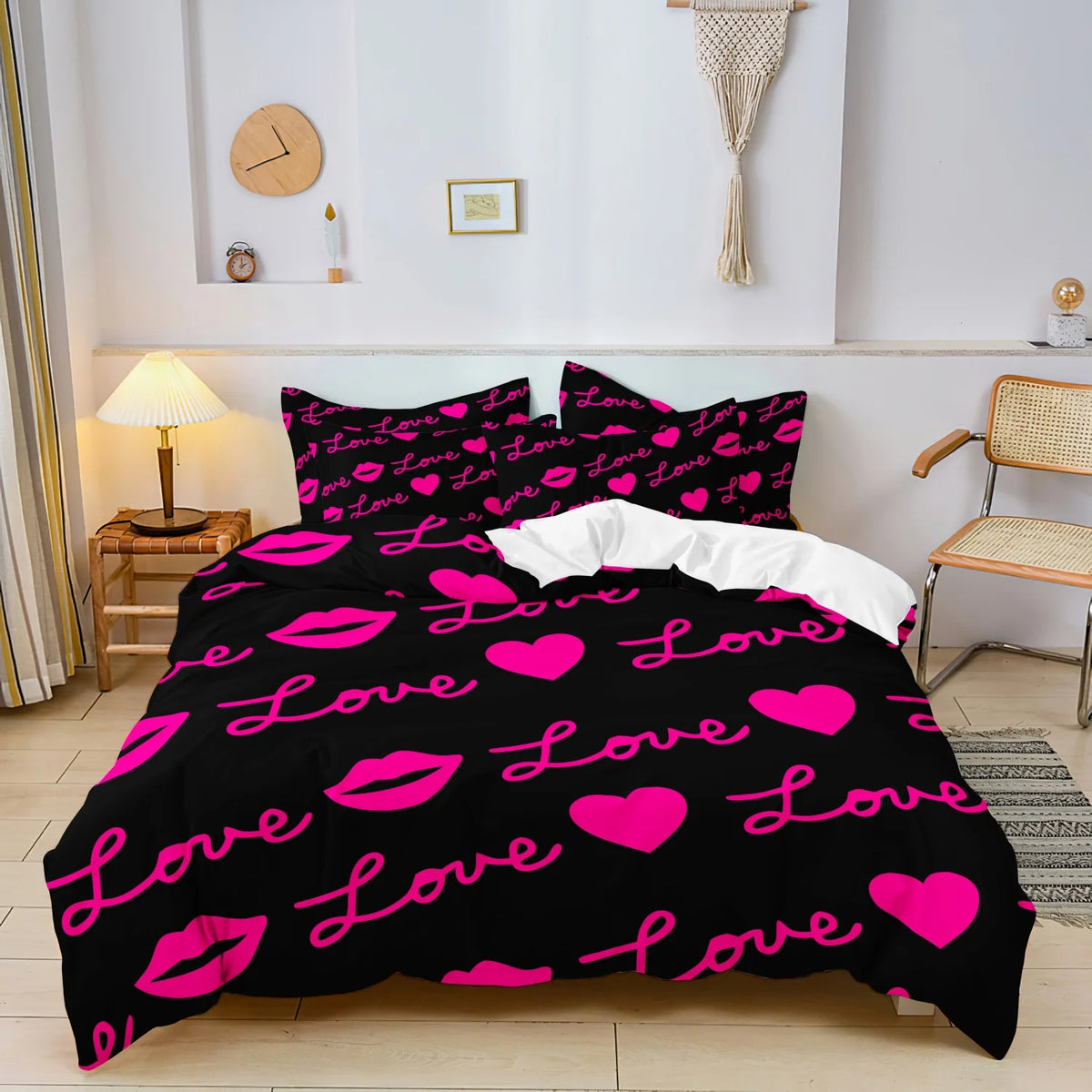 Black duvet cover set with a vibrant pink lips print featuring hearts and text on a bed.