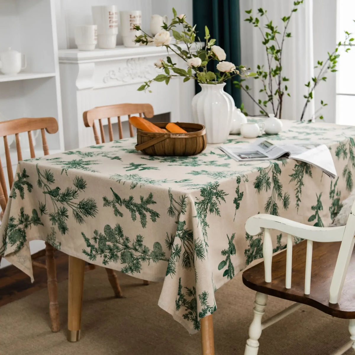 A table covered with a cotton-linen tablecloth featuring a rustic fern print, set in a bright room.