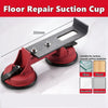 A black floor repair suction cup tool with a red base and a metal plate, shown in a close-up view.