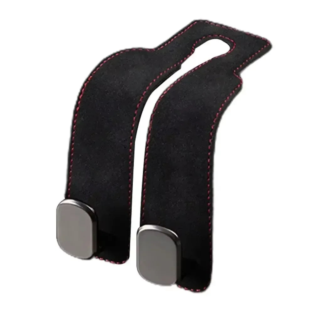 Black suede dual hooks designed for storing handbags and other items in a car seat back.