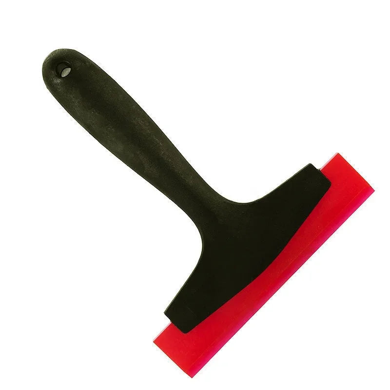A black silicone scraper tool with a red edge used for grout and sealant work.