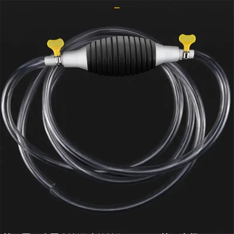 A manual siphon pump with a black ribbed body and yellow connectors is shown connected to clear tubing.