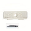 A beige silicone faucet splash guard with a foldable edge and decorative patterns.