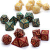A collection of dragon-embellished polyhedral dice in various colors and sizes for tabletop role-playing games