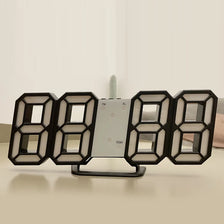 A black 8-digit LED digital wall clock with a temperature display is shown on a light surface.