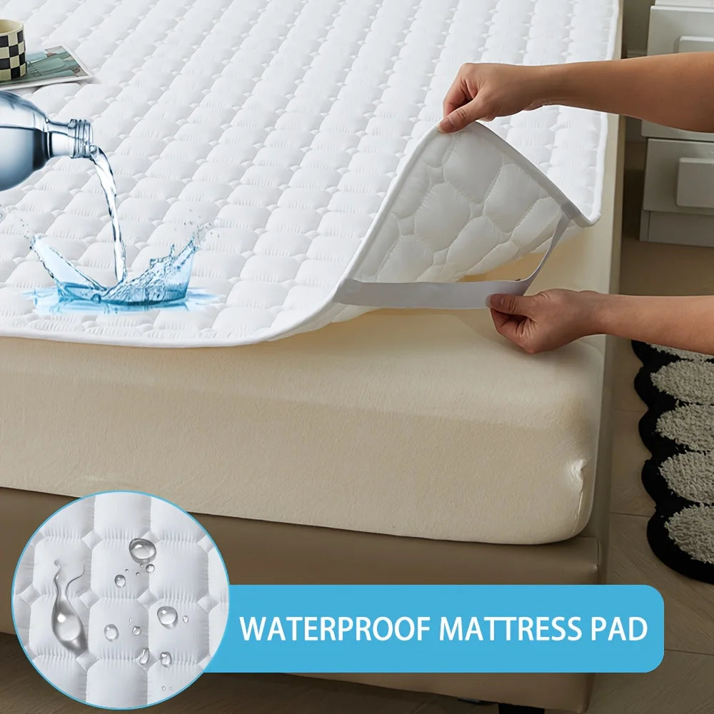 Eine Hand hebt eine weiße wasserdichte gesteppte Matratzenunterlage von einem Bett und demonstriert ihren Schutz.