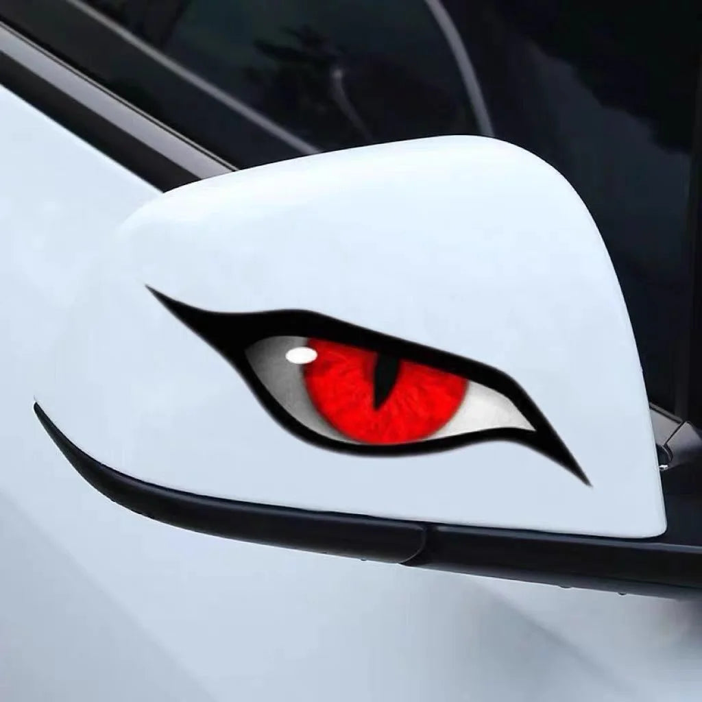 Close-up of a white car surface featuring a black and red cat eye decal design.