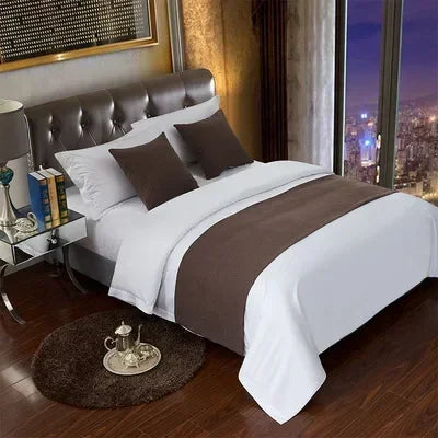 A luxurious bed featuring a soft knit decorative runner cover in brown and white tones.