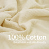 Close-up of a light beige, breathable 100% cotton fabric draped and folded.