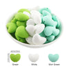 A collection of ten silicone heart beads in green, white, and mint green colors displayed in a white bowl.