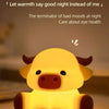 A yellow silicone night light shaped like a Highland cow resting on a surface.