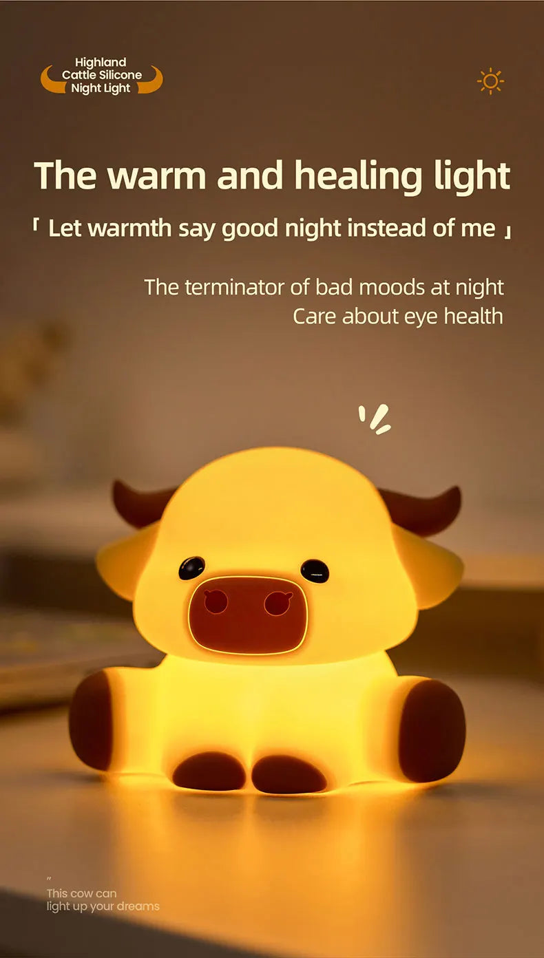 A yellow silicone night light shaped like a Highland cow resting on a surface.