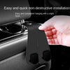 A hand is installing a non-destructive hanging hook onto a car headrest for bags and organizers.