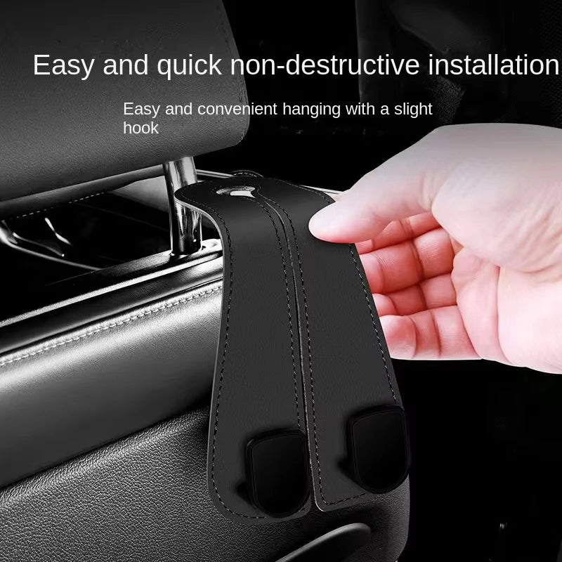 A hand is installing a non-destructive hanging hook onto a car headrest for bags and organizers.