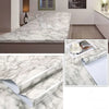 Roll of waterproof self-adhesive marble wallpaper featuring white and gray veining for interior design