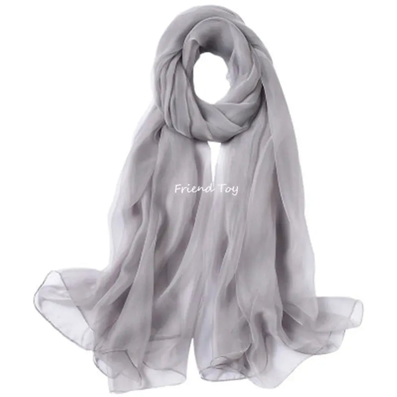 A sheer gray silk scarf draped around a neck and shoulders for imaginative play.