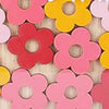 Assortment of colorful wooden flower shapes used as a cartoon reward jar for positive behavior