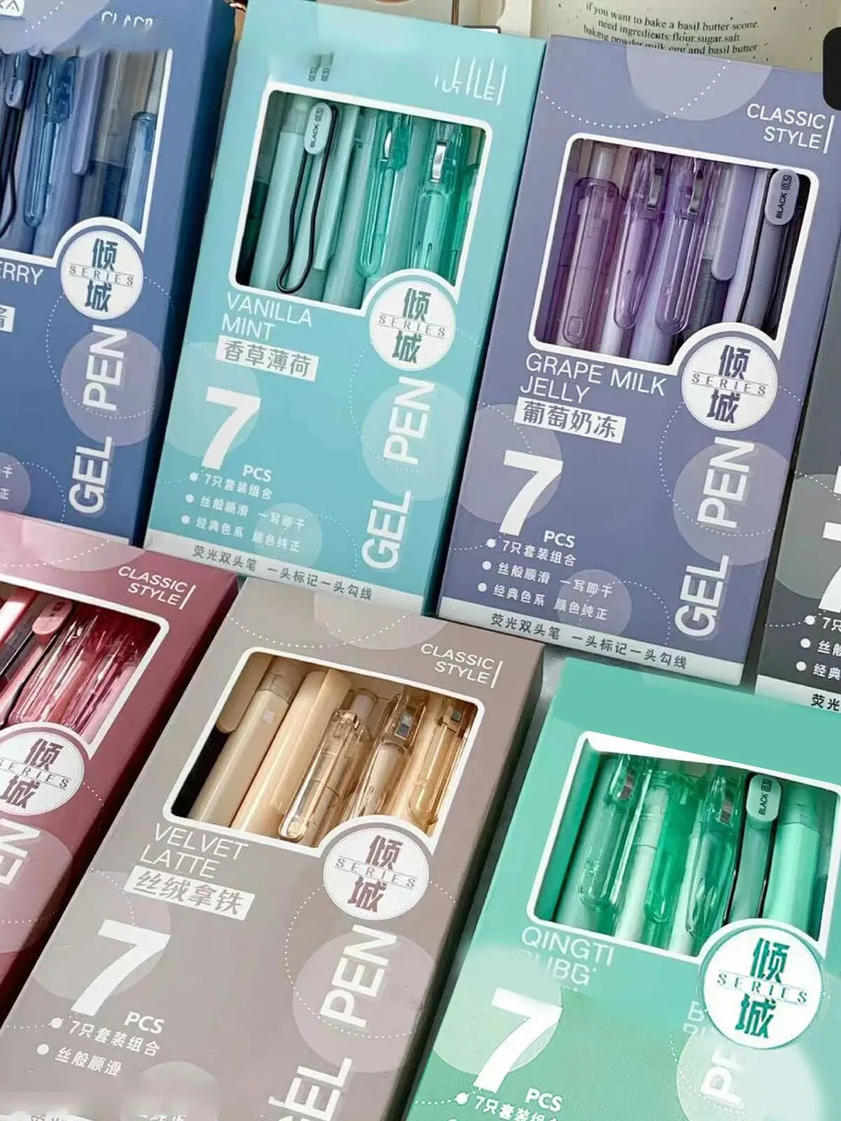 A collection of seven minimalist clear gel pens in various shades including mint, olive green, and purple.