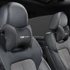 Black memory foam car seat headrest neck pillow shown in a vehicle interior.