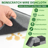 A hand is holding a black non-scratch wire dishcloth, showing its texture and use for cleaning.
