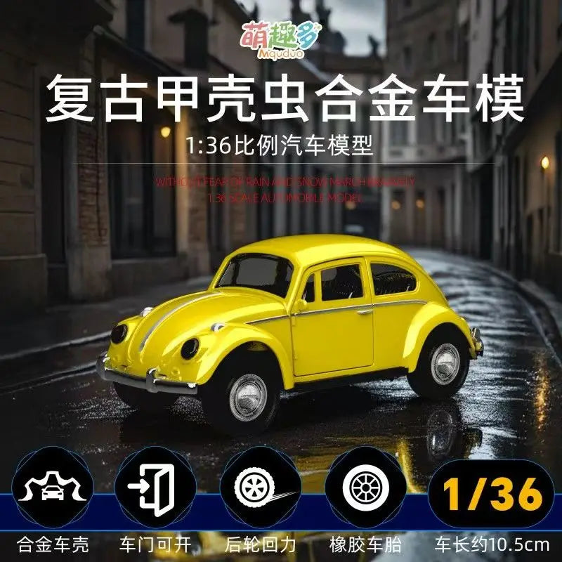 A yellow 1/36 scale die-cast model of a vintage Volkswagen Beetle car on a wet street.
