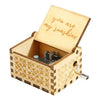 A hand-cranked wooden music box with a lid engraved 'you are my sunshine' and decorative wood carving.