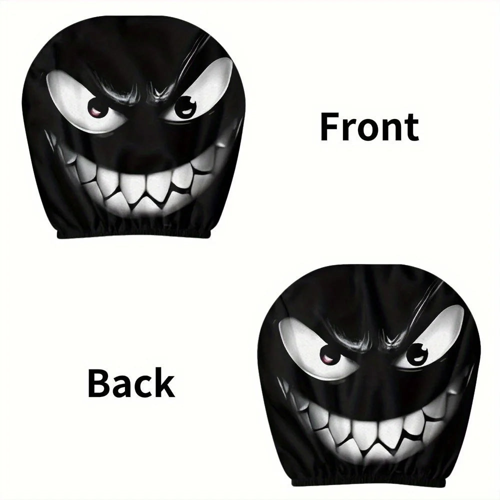 A pair of black headrest covers featuring a menacing evil grin design, shown from the front and back.