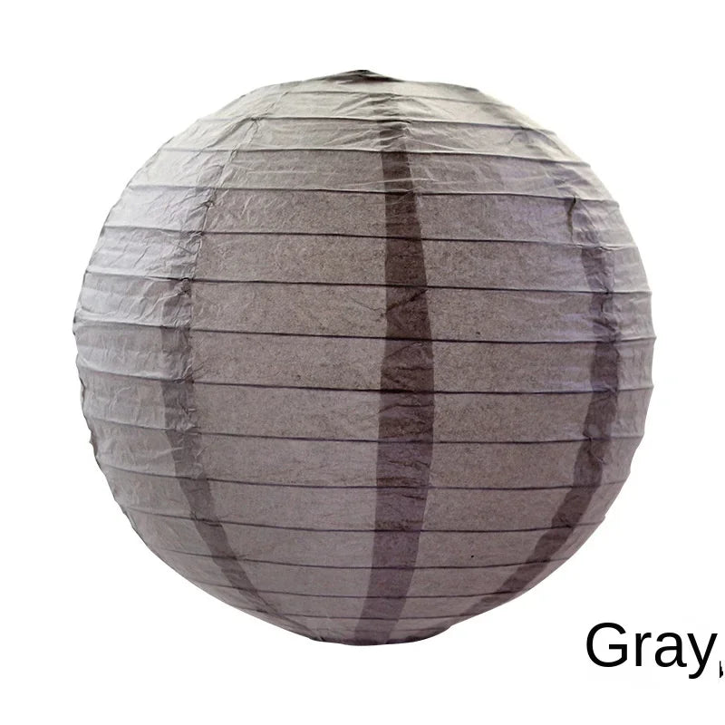 A round, gray paper lantern with vertical folds.