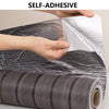 Hands are applying self-adhesive wood grain wall panels to a surface.