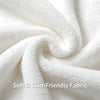 A close-up of a white, soft, high-density fabric textile being tightly rolled.