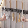 Wall-mounted metal holder for mop and broom with detachable hooks and wooden handles
