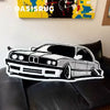 A black and white cartoon print plush carpet depicting a classic car on a black leather sofa.