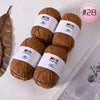 A collection of brown Milk Cotton yarn balls for knitting and crochet projects.