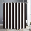 Black and white vertical striped shower curtain hanging from a metal rod in a bathroom setting.