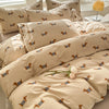 A beige duvet cover set featuring a cute dog print pattern on the fabric.
