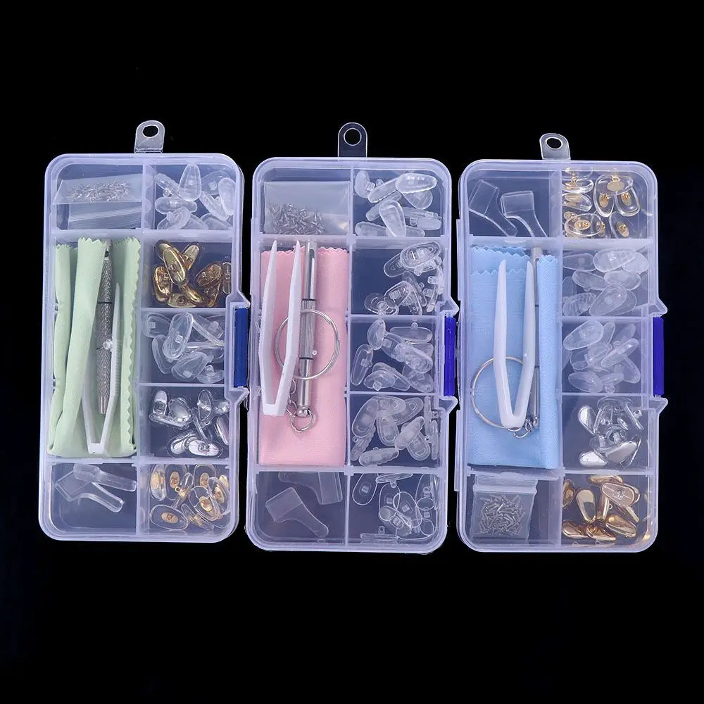 A clear plastic kit containing various glasses repair tools including nose pads, screws, and precision instruments.